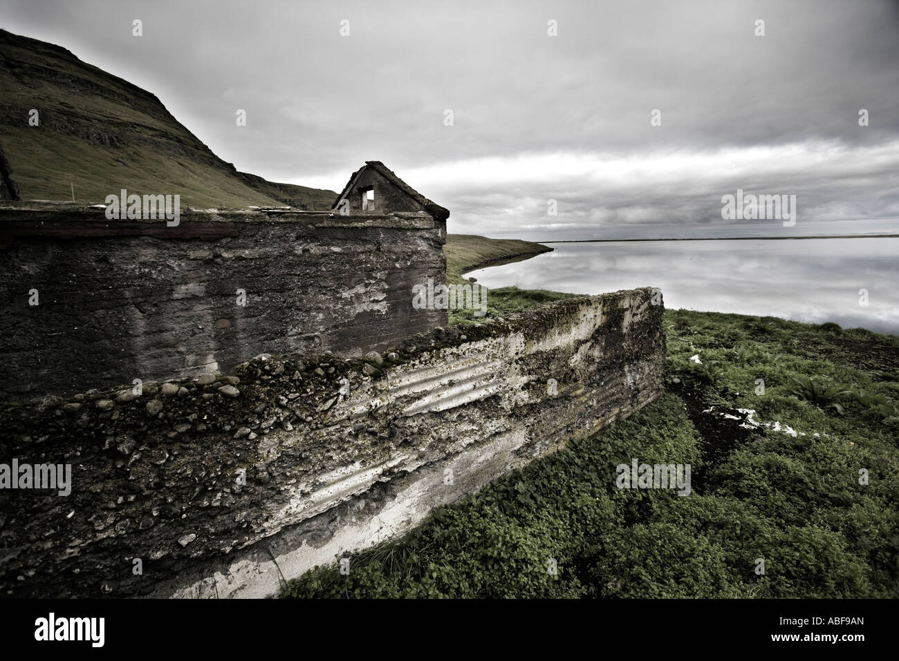 Coastal cliff viewed through the window of an old abondoned house Stock Photo
