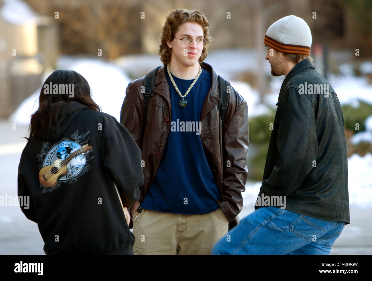 Three university students talk outside on the University of Nebraska campus in Lincoln. Stock Photo