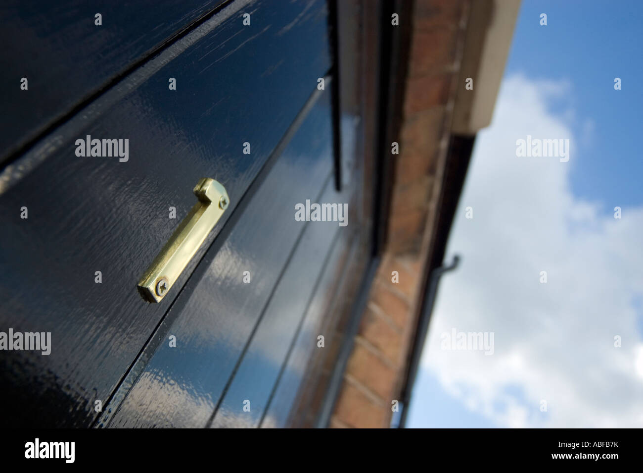 a brass number one the door of a small hotel room Stock Photo