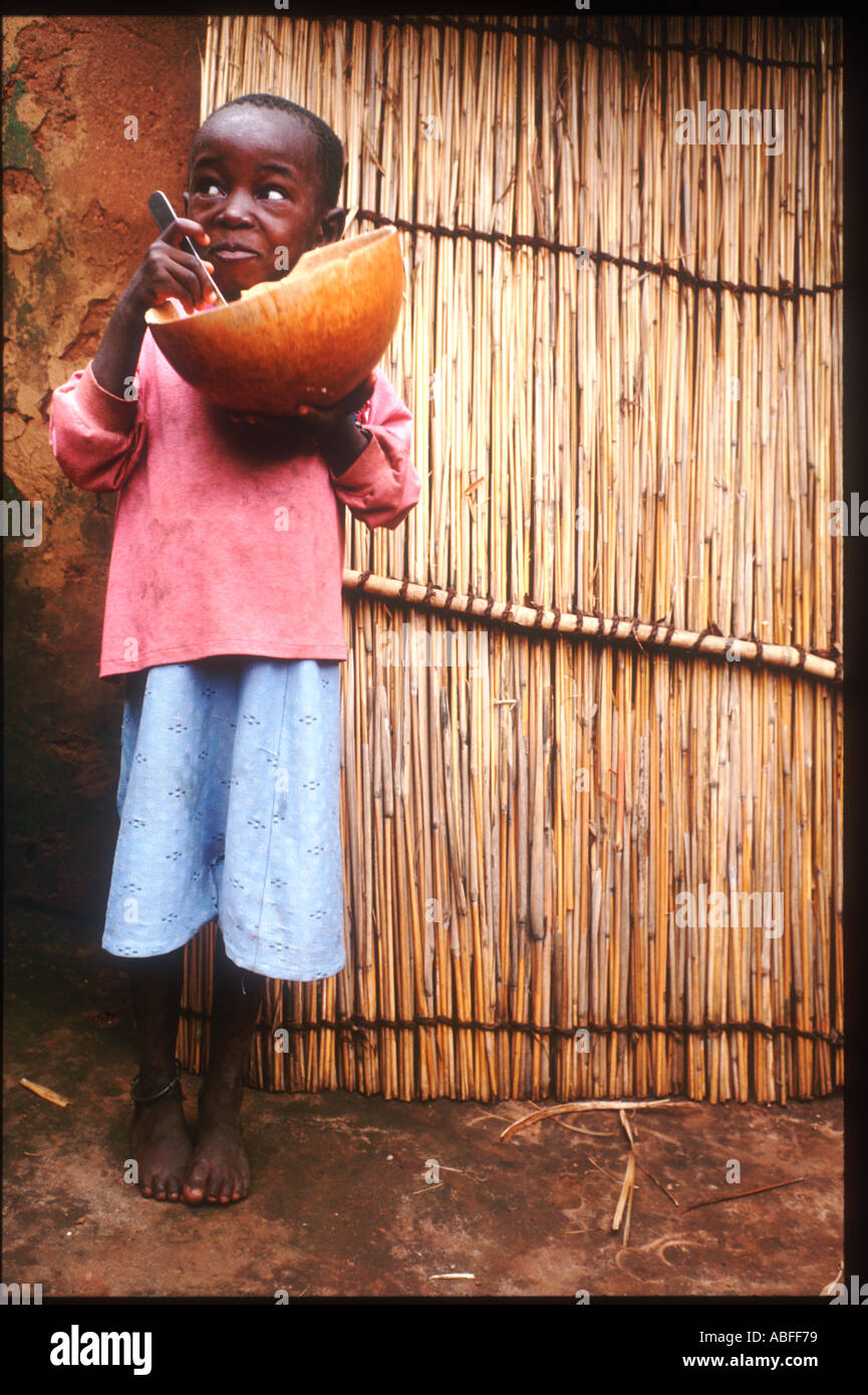 A Boy in Togoville eating his lunch Togoville is a village near Lake Togo in Togo Stock Photo