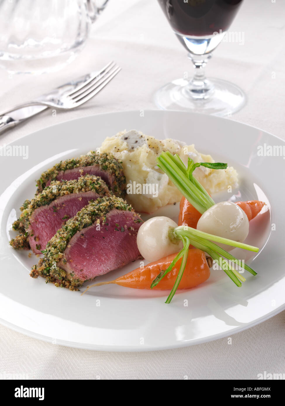A plate of lamb loin in a herb crust with vegetables editorial food Stock Photo