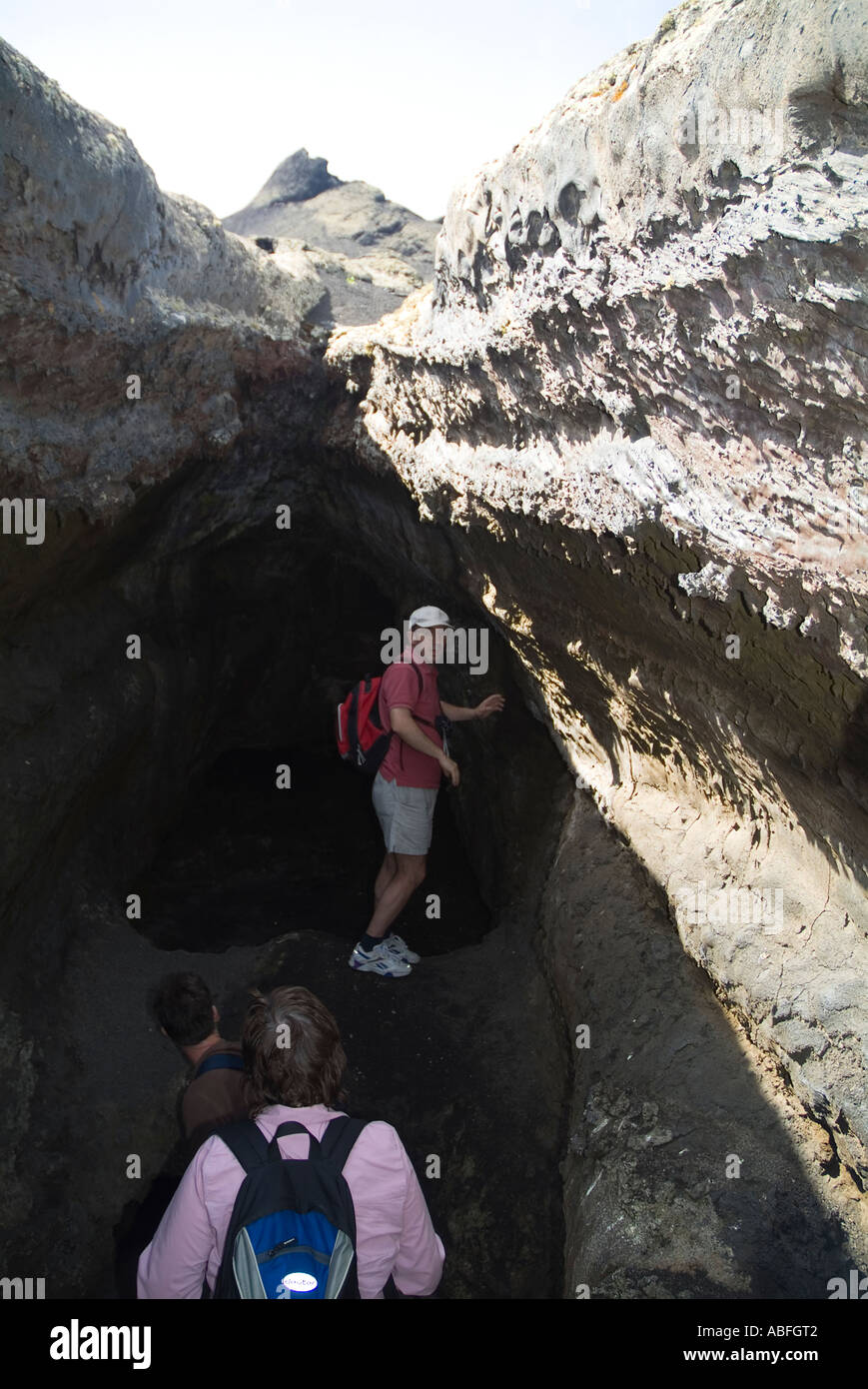 dh Timanfaya National Park TIMANFAYA LANZAROTE Guided tour hikers trekking in pahoehoe lava flow volcanic tunnel cave people Stock Photo