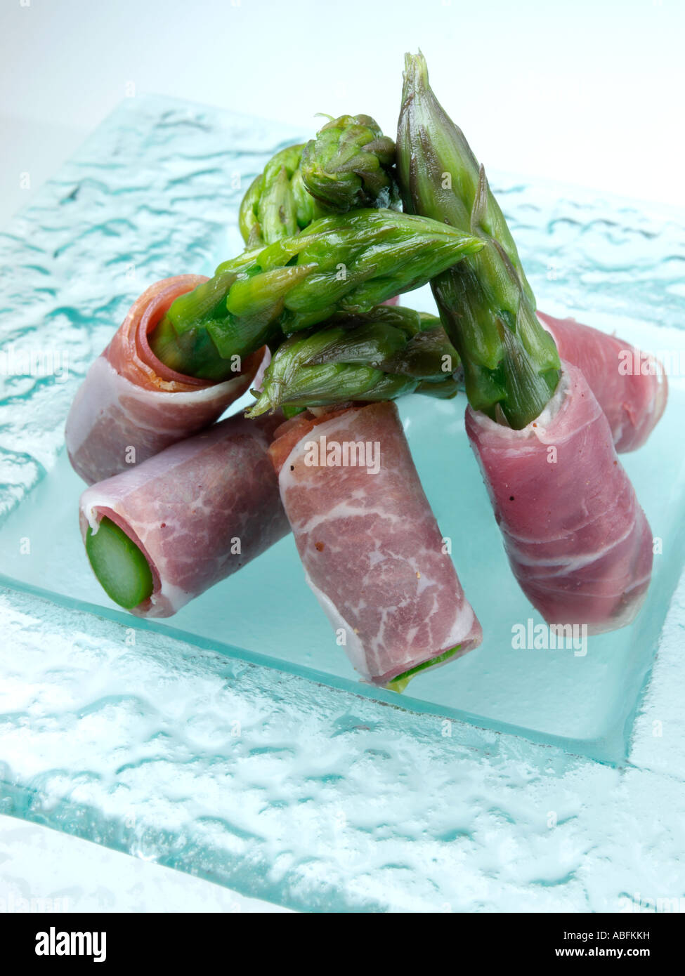 A plate of asparagus spears wrapped in parma ham canapes Stock Photo