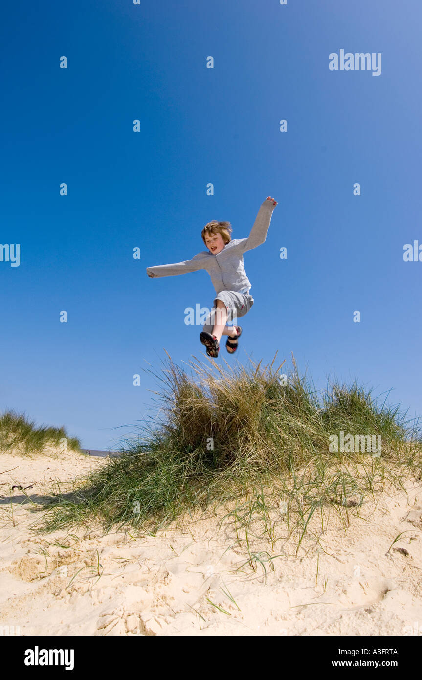Young Child Jumping Sand Dunes Stock Photo Alamy