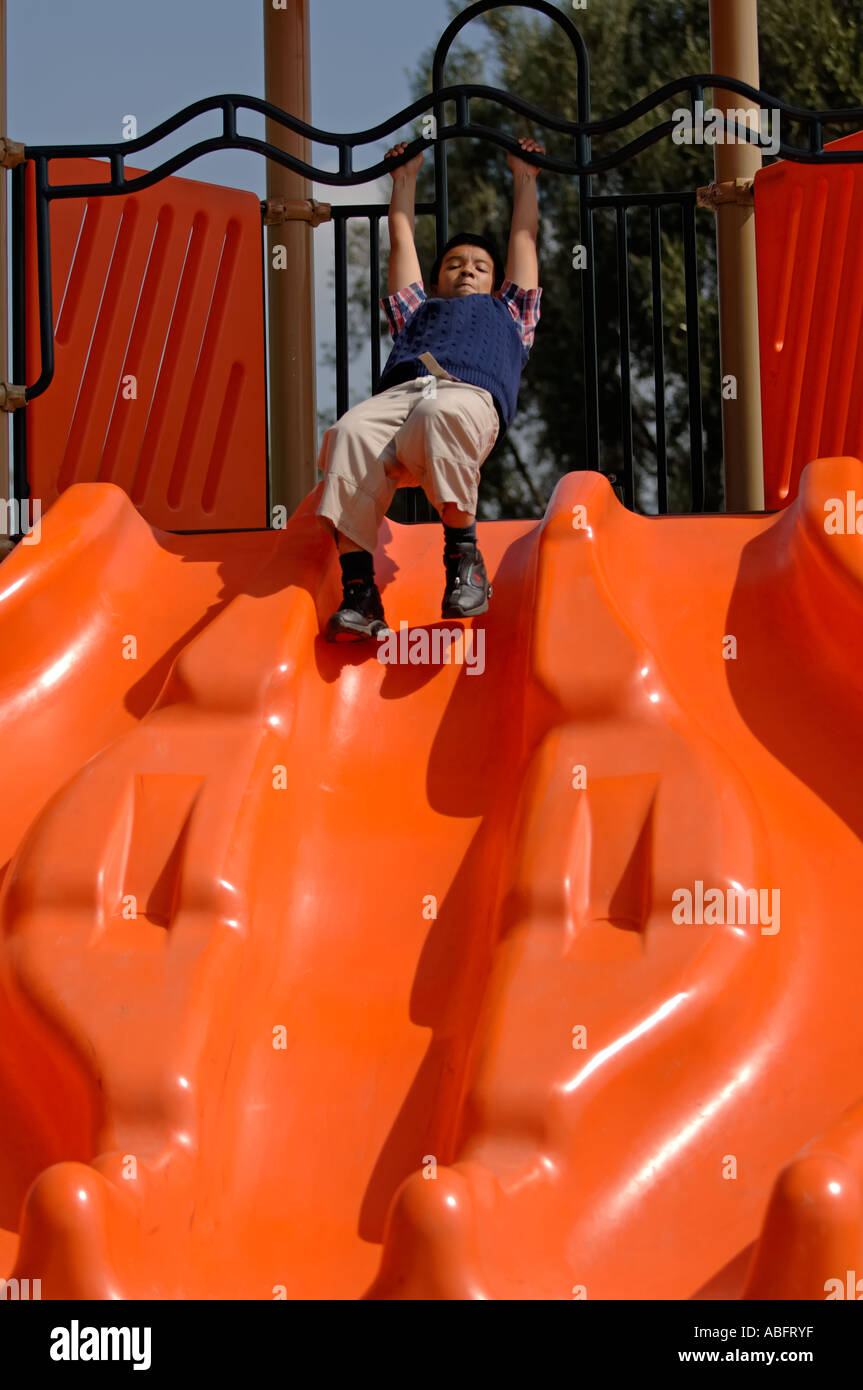 Boy about to slide down slider Stock Photo Alamy