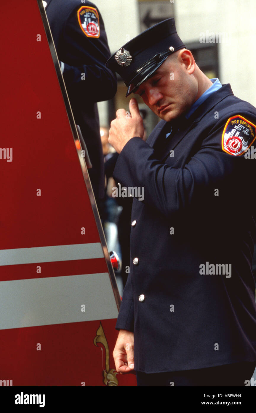A distraught fireman at funeral post September 11, 2001 terrorist attacks at the World Trade Center, New York City. Stock Photo