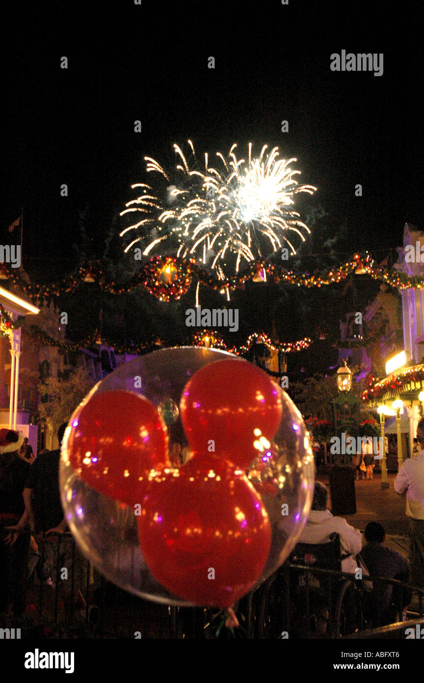Florida Walt Disney World Christmas fireworks with Mickey Mouse balloon in foreground Stock Photo