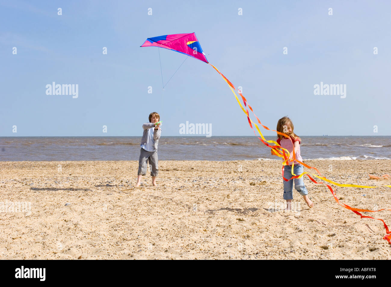 Young Girl Chasing Kite Tail Stock Photo Alamy