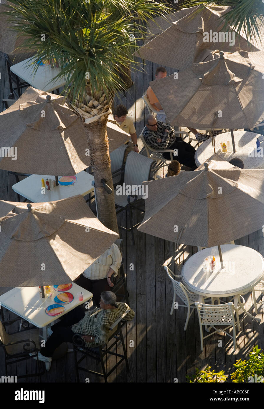 People sitting under umbrellas at a resort Stock Photo
