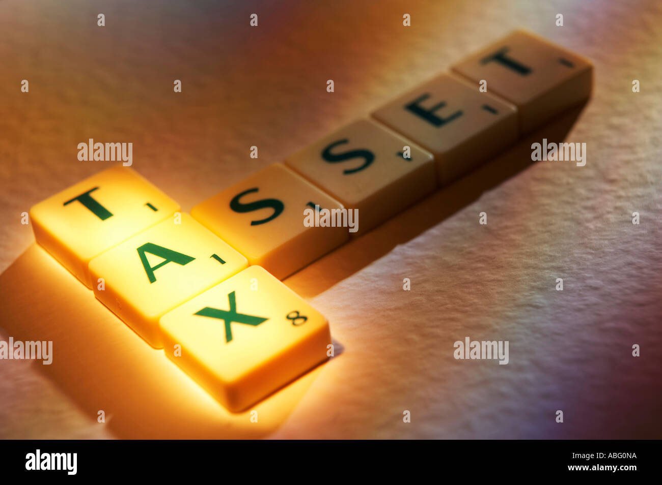 SCRABBLE BOARD GAME LETTERS SPELLING THE WORDS TAX ASSET Stock Photo