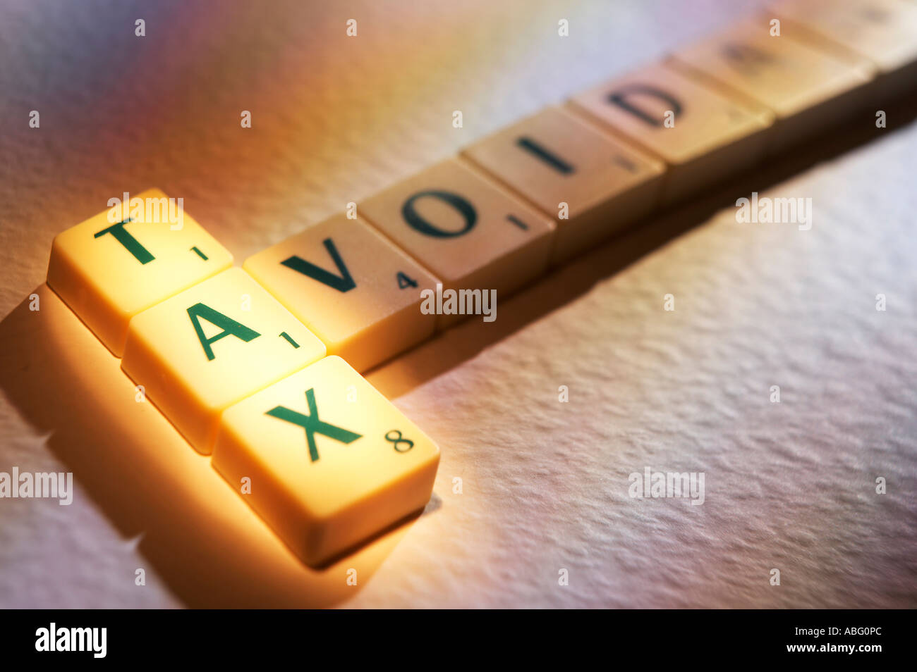 SCRABBLE BOARD GAME LETTERS SPELLING THE WORDS TAX AVOIDANCE Stock Photo