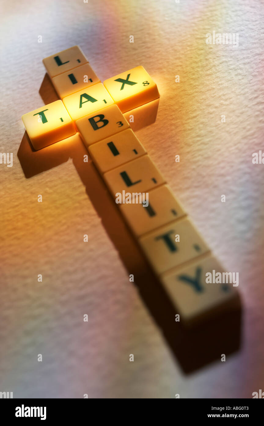 SCRABBLE BOARD GAME LETTERS SPELLING THE WORDS TAX LIABILITY Stock Photo