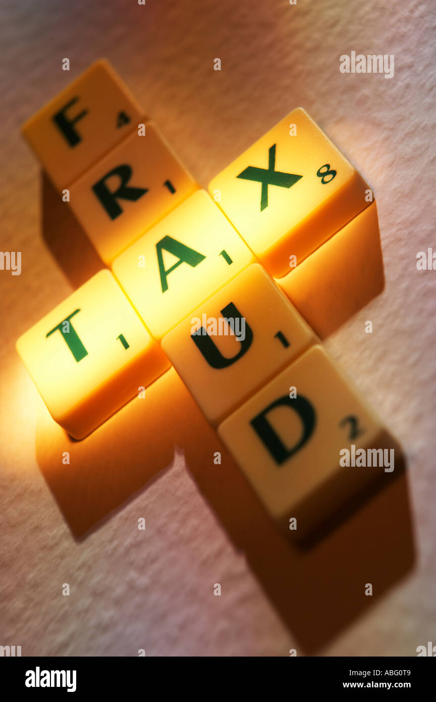 SCRABBLE BOARD GAME LETTERS SPELLING THE WORDS TAX FRAUD Stock Photo