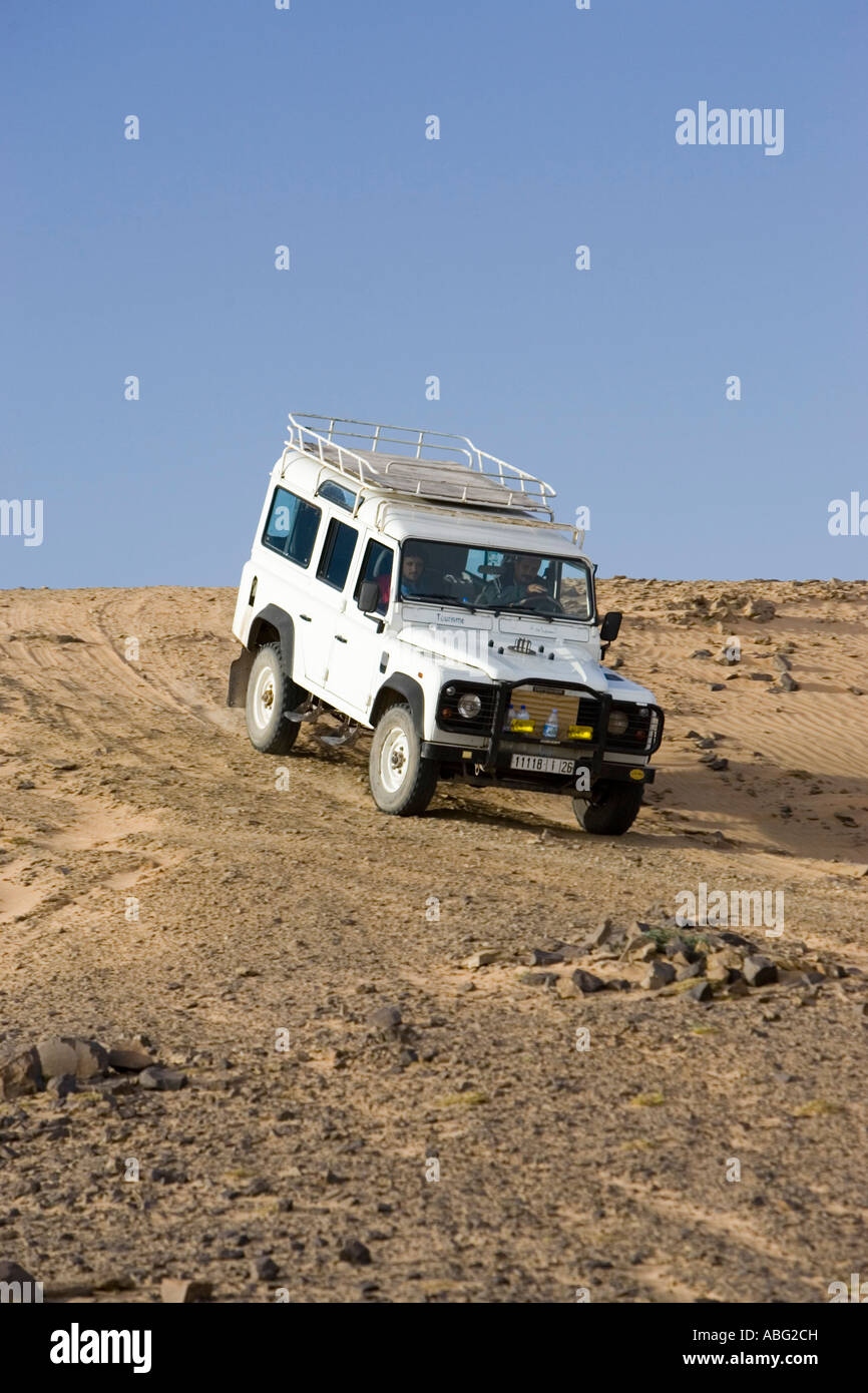 Land Rover Defender four wheel drive vehicle on piste desert track hill near Erg Chebbi east
