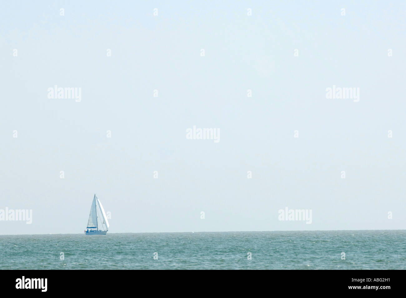 Yat sailing along horizon line Meresea Island Stock Photo