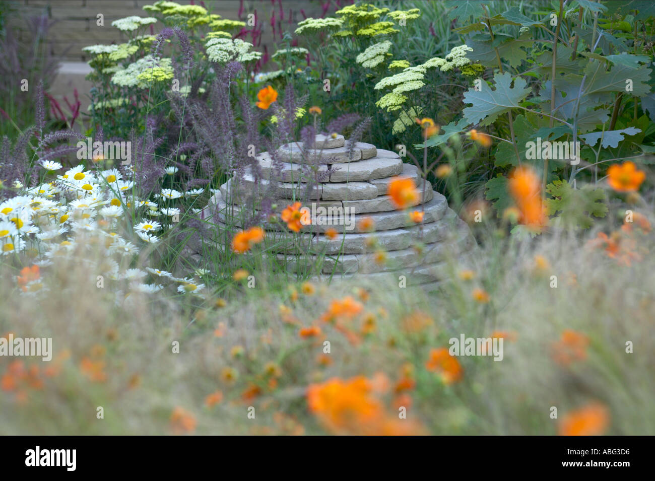 cottage garden border with stone feature built by craftsman Stock Photo