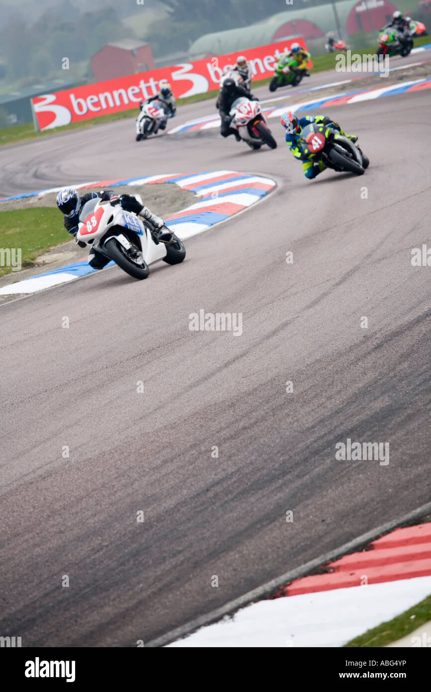 nine racing motorbikes riders leaning through the bends and corners of ...