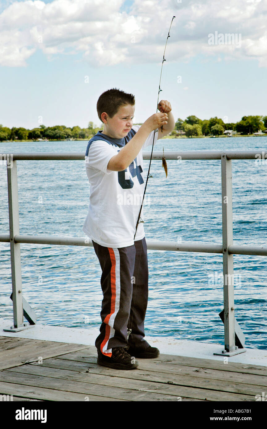 10 year old boy prepares his fishing pole and line with bait Stock Photo - Alamy 10 year old boy prepares his fishing pole and line with bait Stock Photo - Alamy