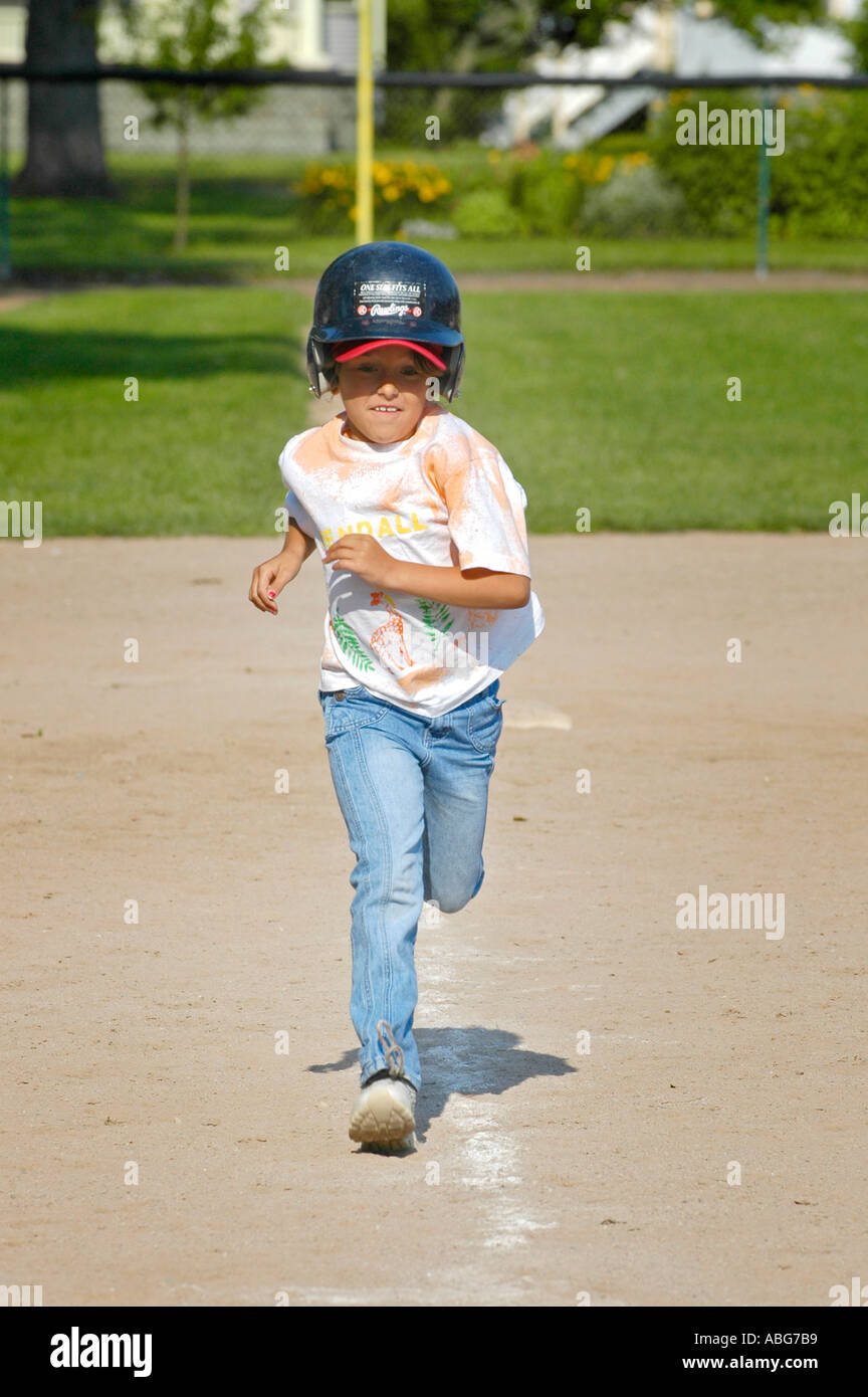 5 year old running girl learns to play baseball Stock Photo