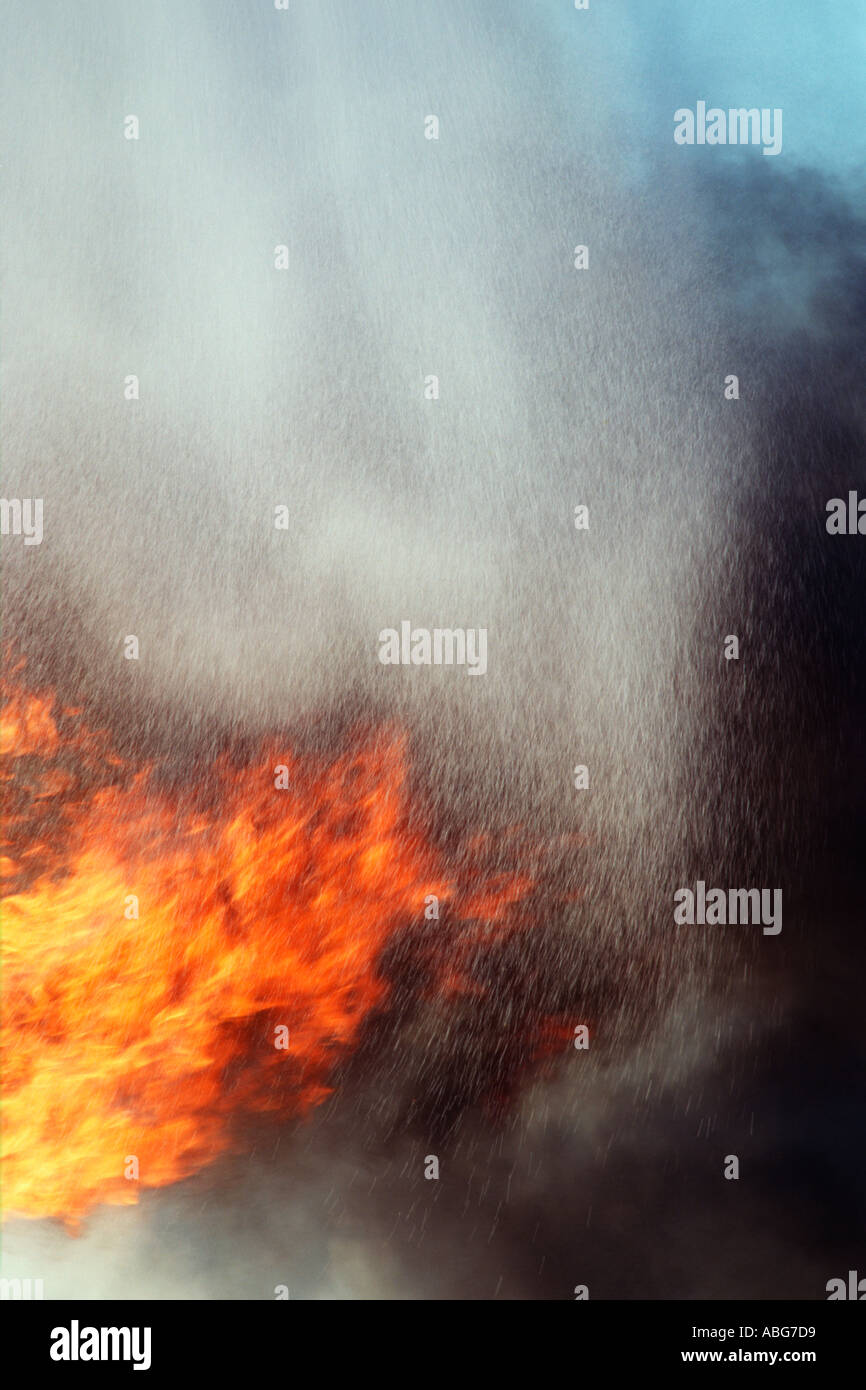 Pouring water on burning fire outdoors Stock Photo Alamy