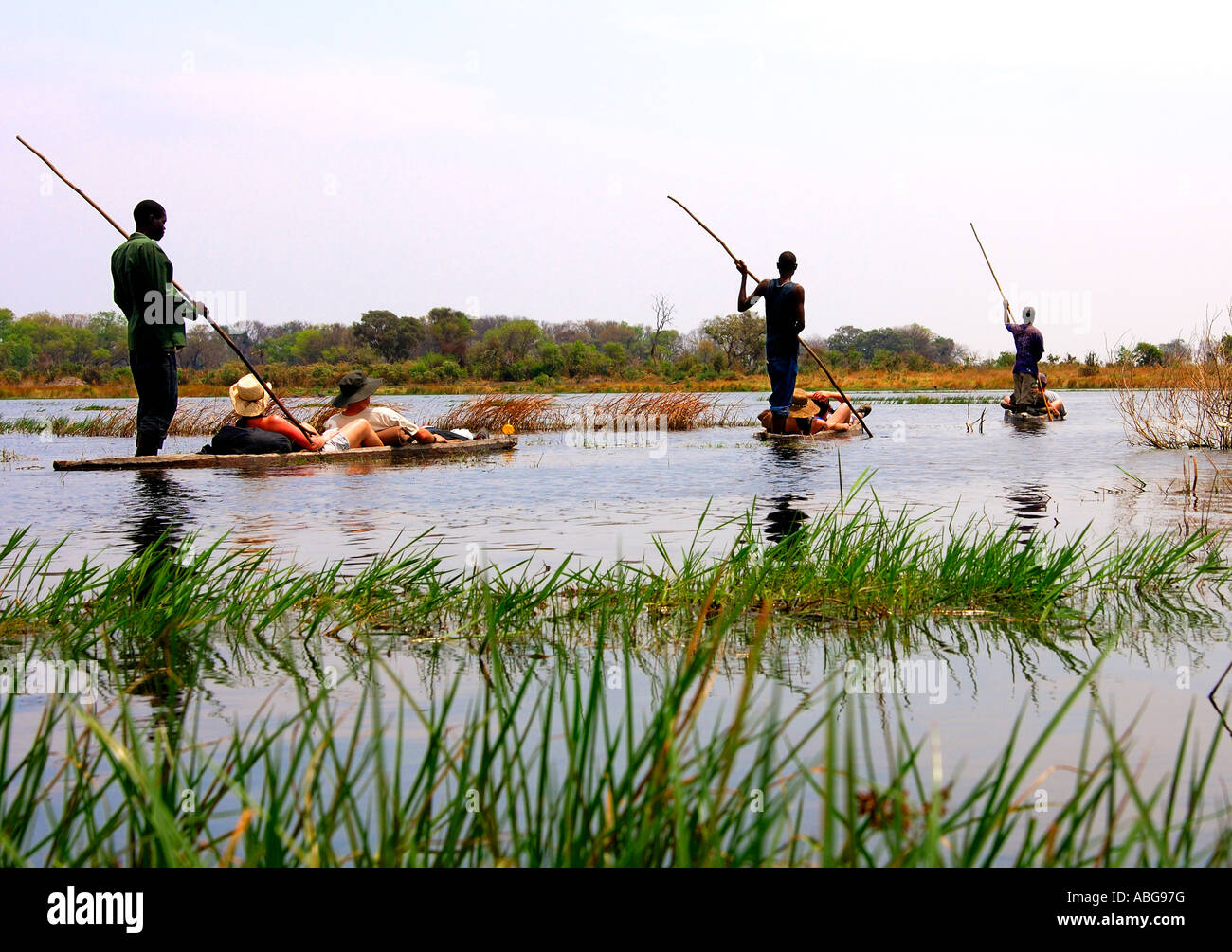 Tourists on trip in a Mokoro canoe in the Okavango Delta, Botswana Stock Photo