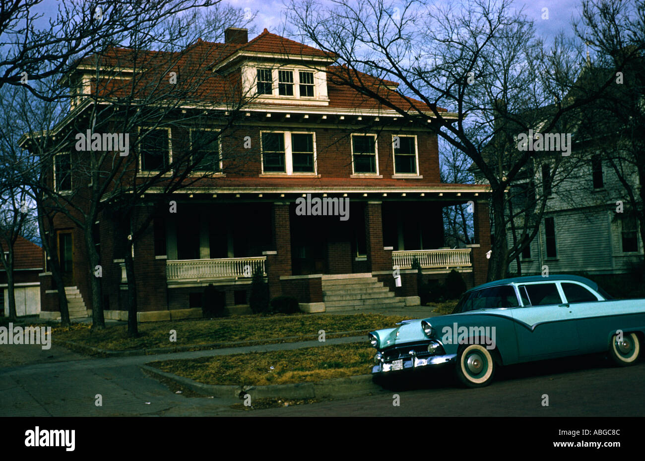America 1950s with a classic timber framed house and a two tone american car parked outside Stock Photo
