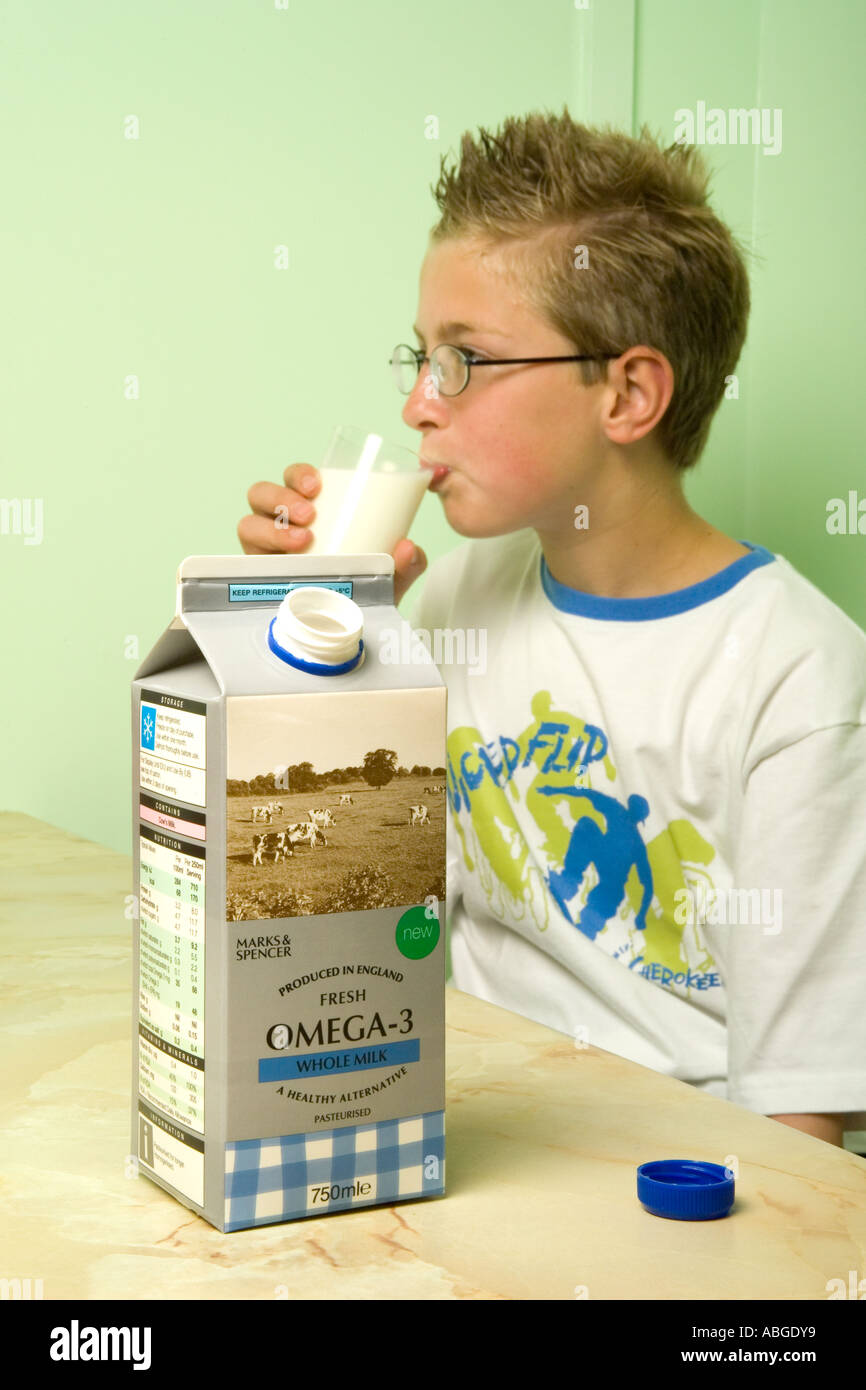 Intellegent boy drinking milk fortified with omega3 fish oils Stock