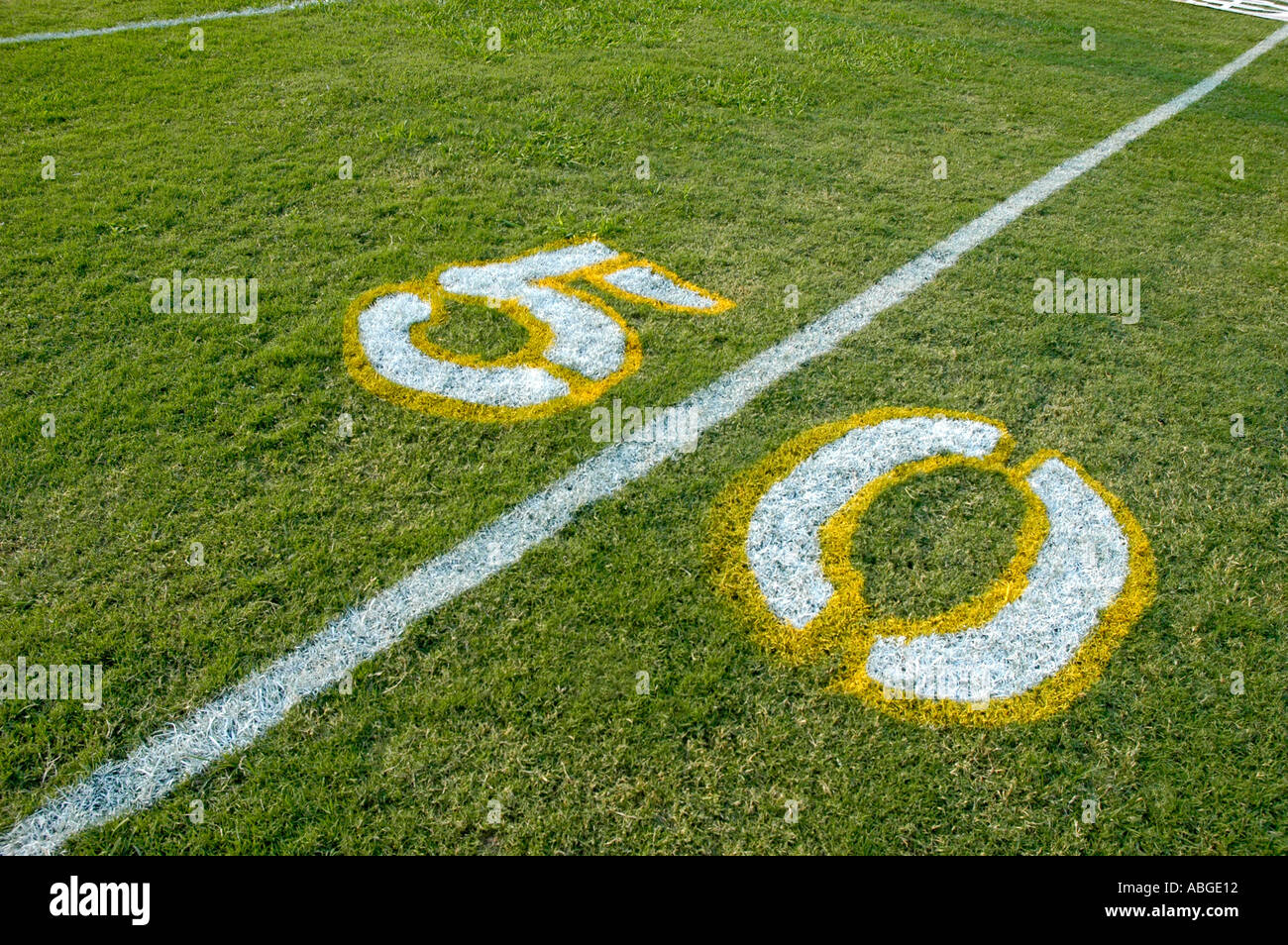 Painting yardage numbers and logos on football fields in preparations