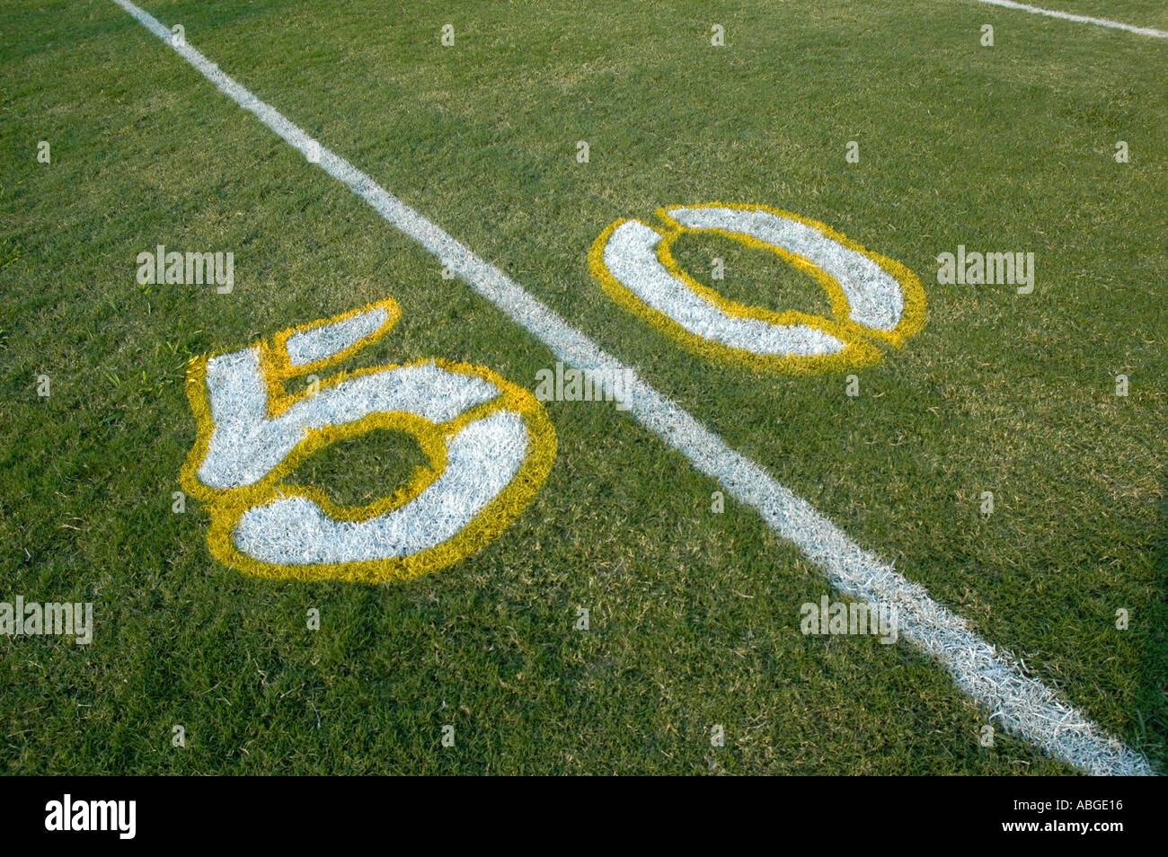 Painting yardage numbers and logos on football fields in preparations