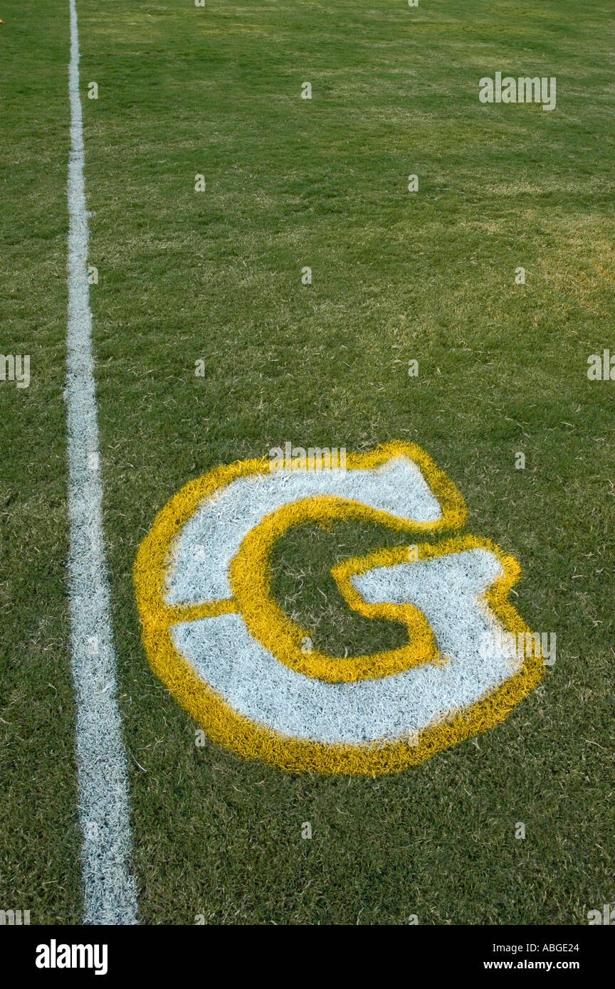 Painting yardage Goals touchdown numbers and logos on football fields