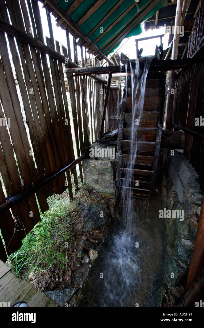 A water wheel is used to thresh and grind rice at a paddy farm in ...