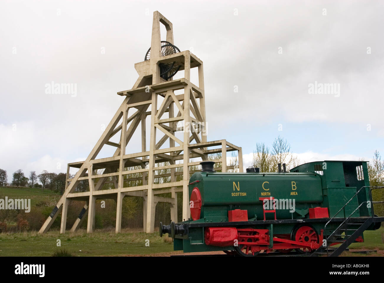 Vintage coal shunting steam train engine and mine pit head Stock Photo