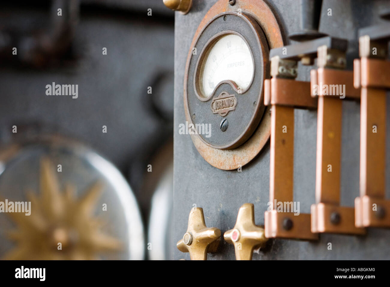 Vintage copper electrical throw breaker switch and current meter on