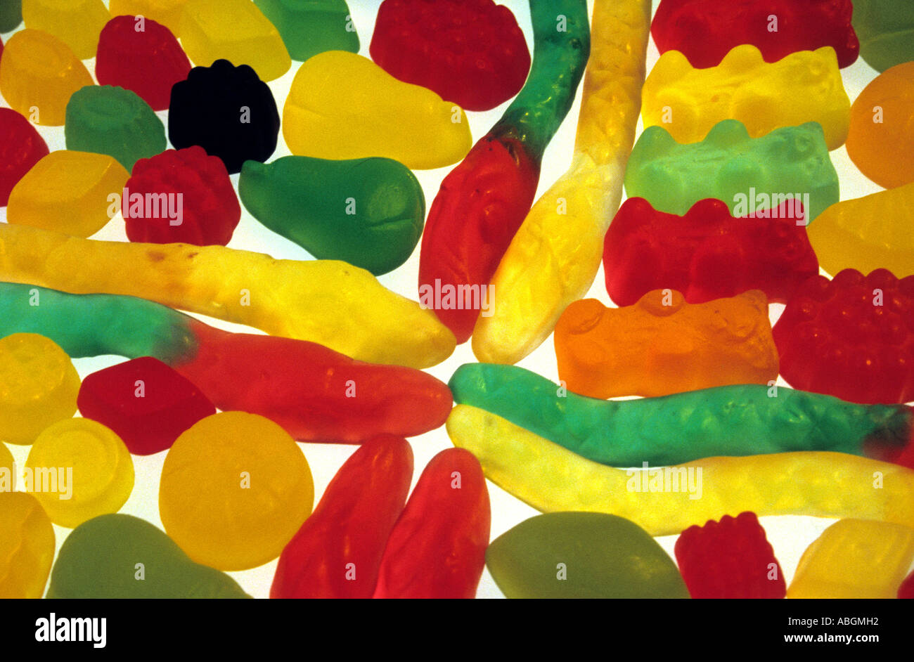 Wine gums gummi bears and snakes on a lightbox Stock Photo Alamy
