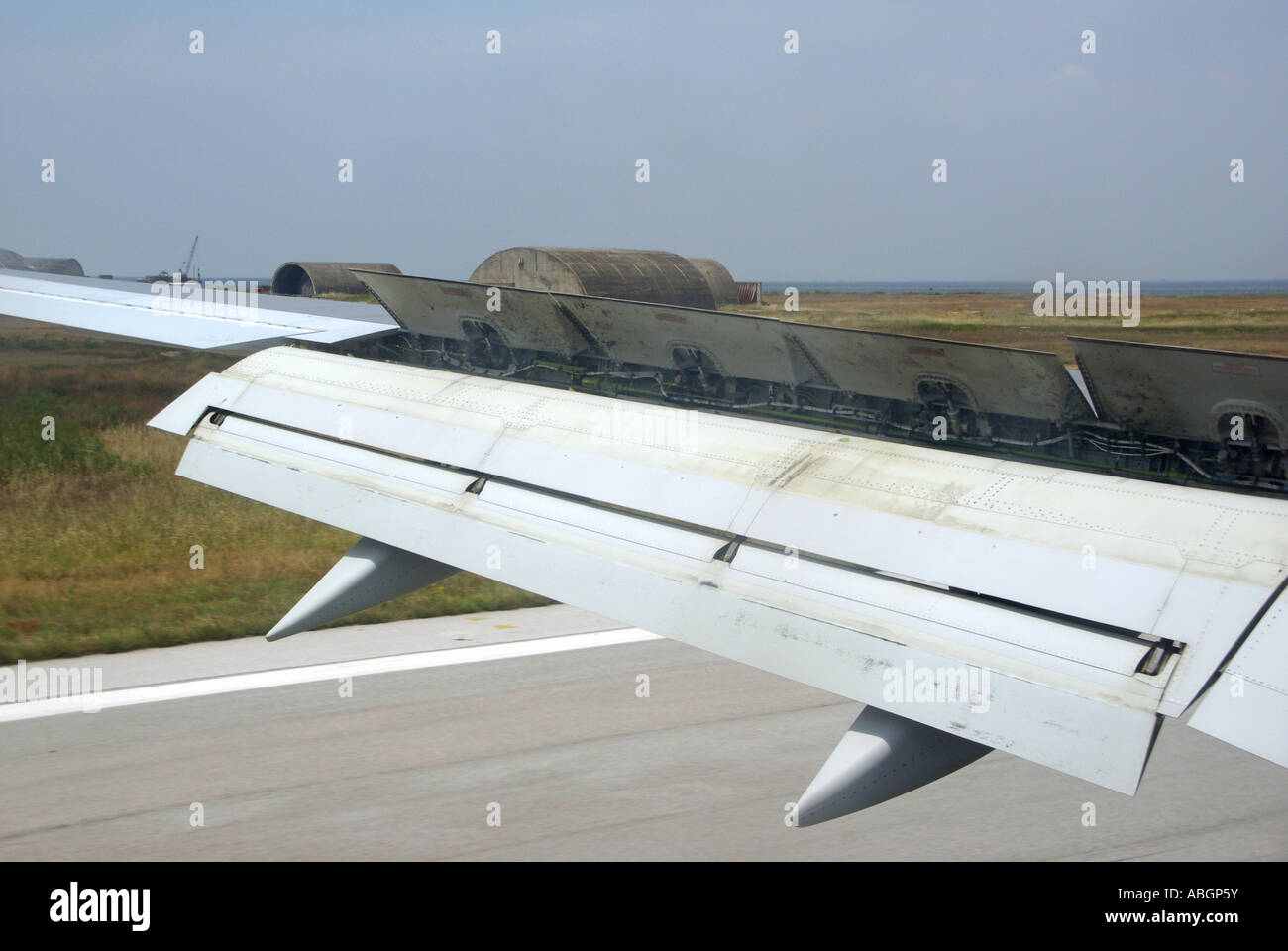 Airliner wing braking deceleration flaps in use close up view during landing at Thessaloniki international airportGreece Europe Stock Photo