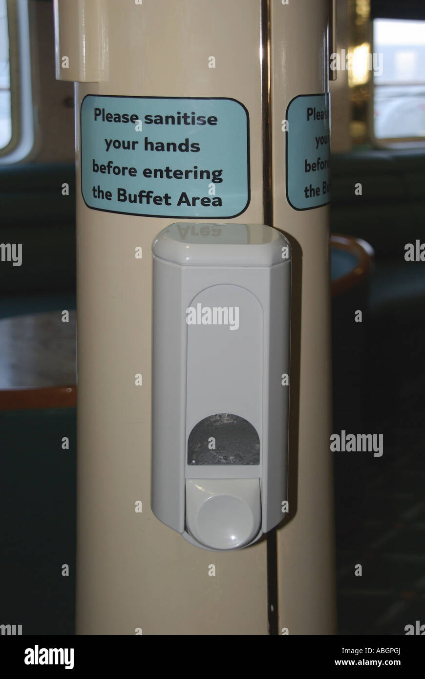 Sanitise hand gel in automatic sanitiser dispenser Norovirus sanitizer precaution at entrance to buffet cruise ship liner for use by passengers & crew Stock Photo