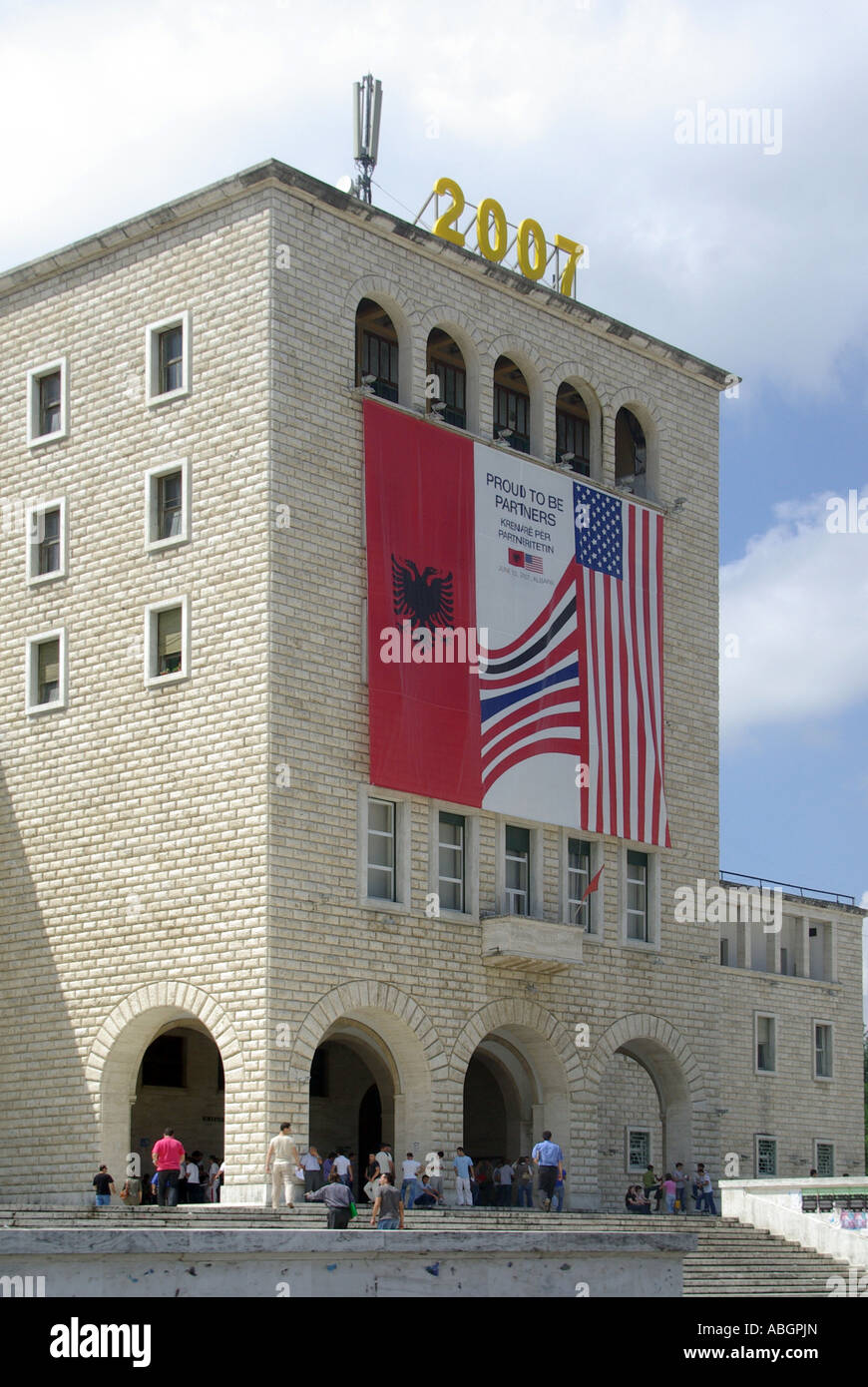 Students & façade of Tirana university building political banner about visit of USA President George W Bush in June 2007 to Republic of Albania Stock Photo