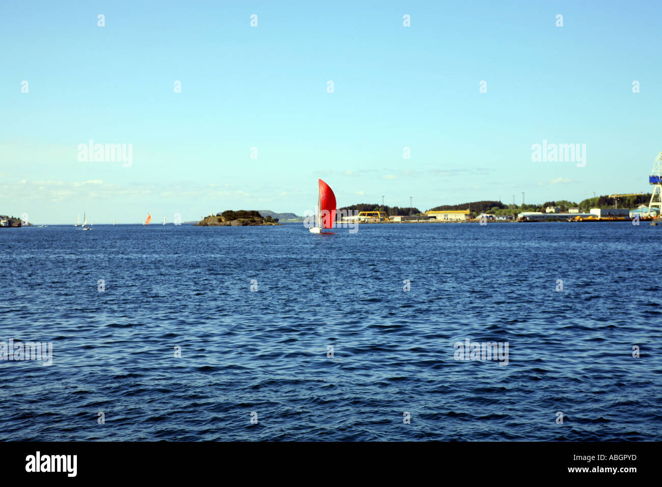 Red sailed sailing dingy, Satvanger, Norway Stock Photo