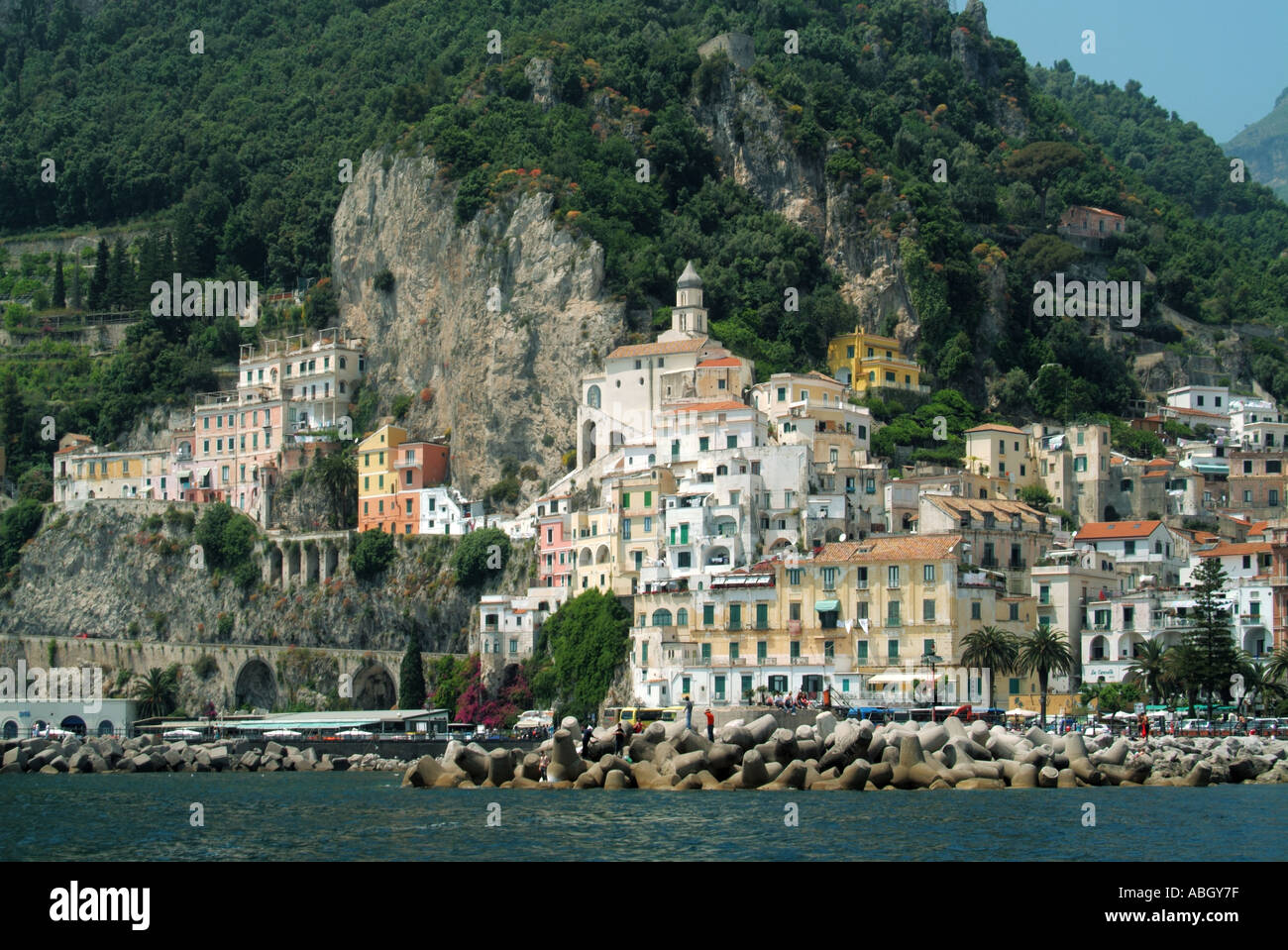 Amalfi coast property view from Tyrrhenian Sea town waterfront protected by Dolosse type precast concrete blocks cliff backdrop Salerno Campania Italy Stock Photo