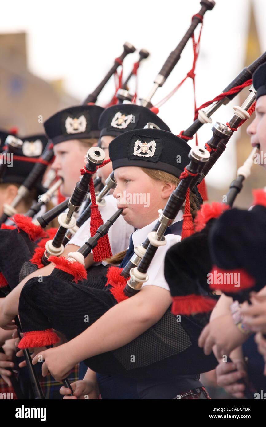 Pipe band young kids playing bagpipes on Annan High Street part of the Annan Riding of the Marches Scotland UK Stock Photo