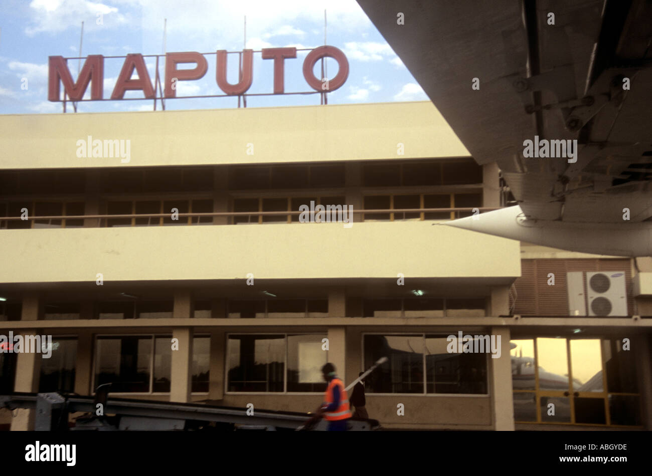 Maputo airport taken from Let 410 aircraft on runway worker visible and wing Mozambique Stock Photo