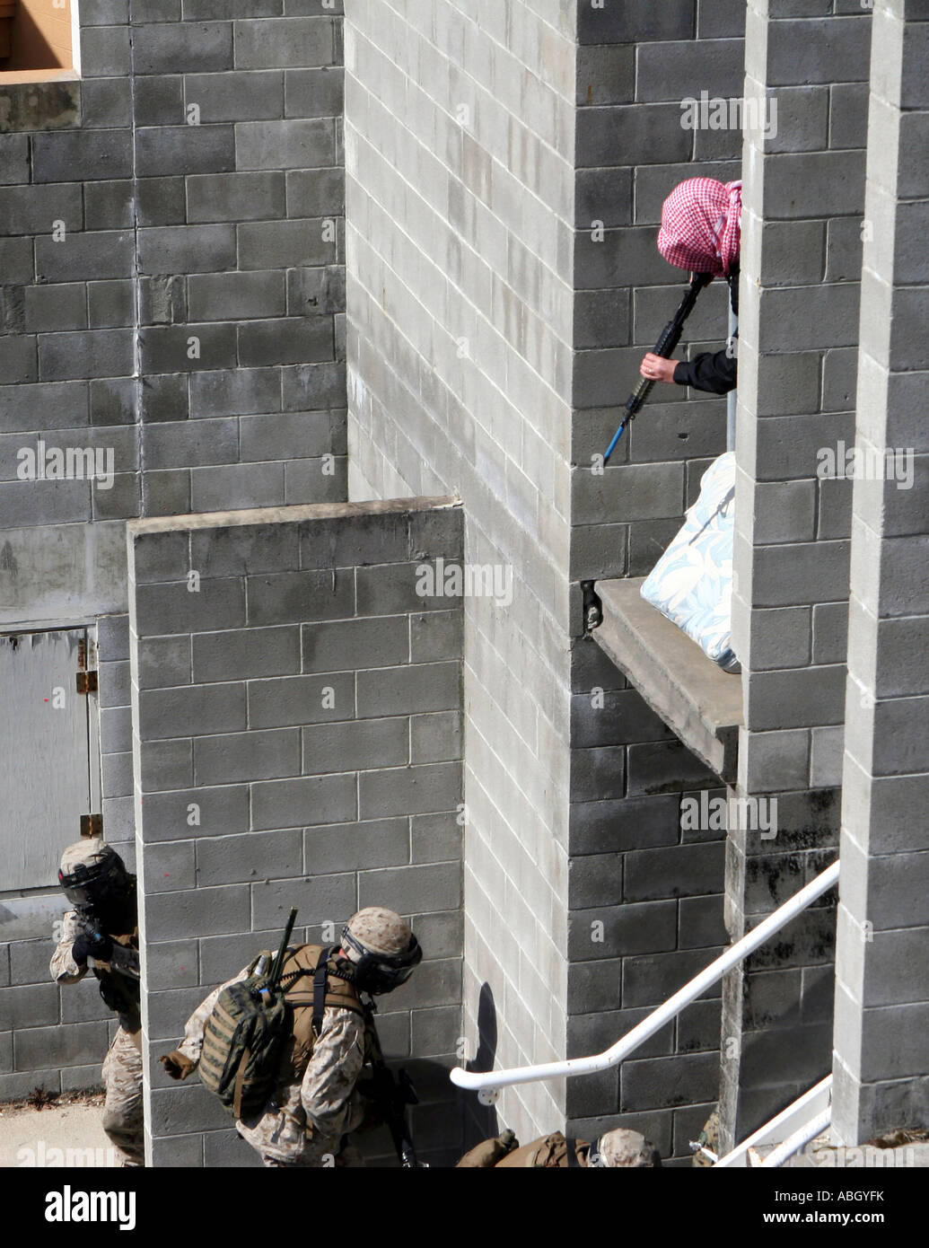 A Marine and role-playing enemy aggressor prepare to square-off with simulated paint rounds. Stock Photo
