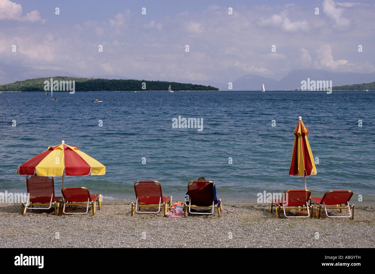 sunshades and deckchairs on the beach of Nidri Lefkada Island Greece Stock Photo