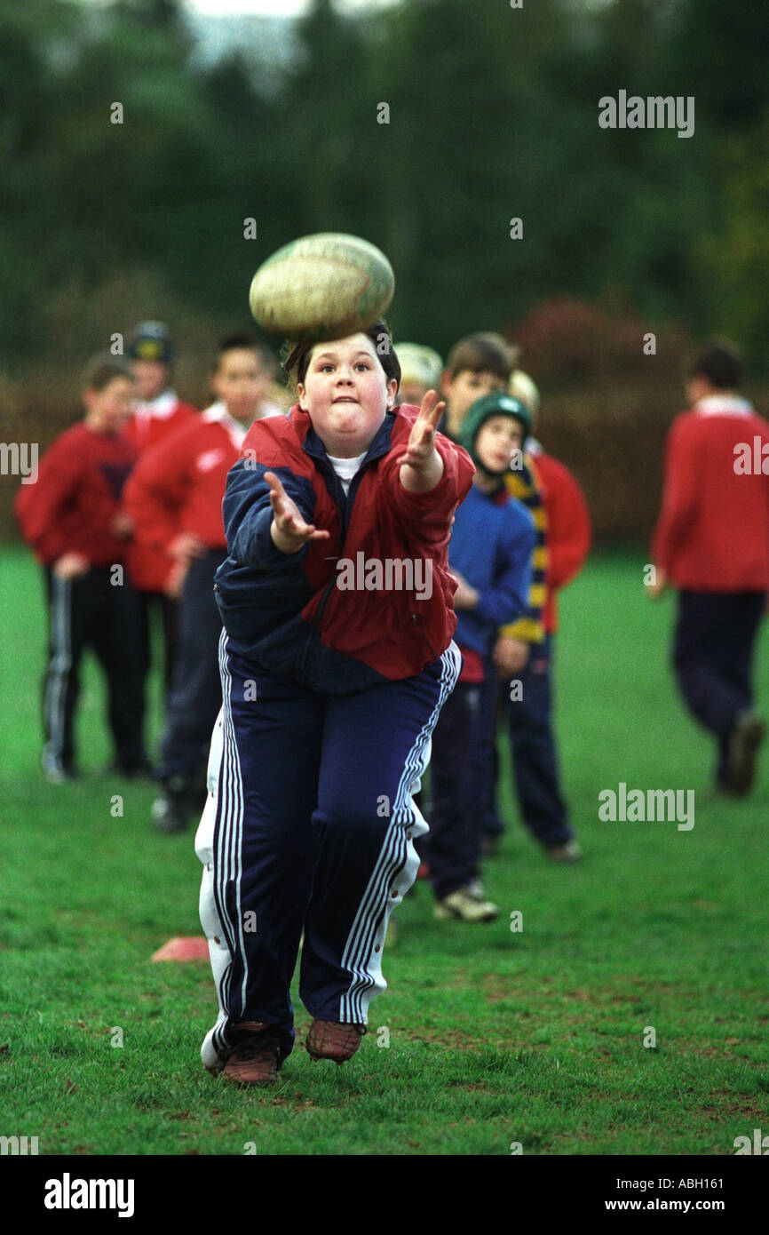 Children boys and girls taking part in a Welsh Rugby Union coaching day to develop ball skills Gwent Wales UK Stock Photo