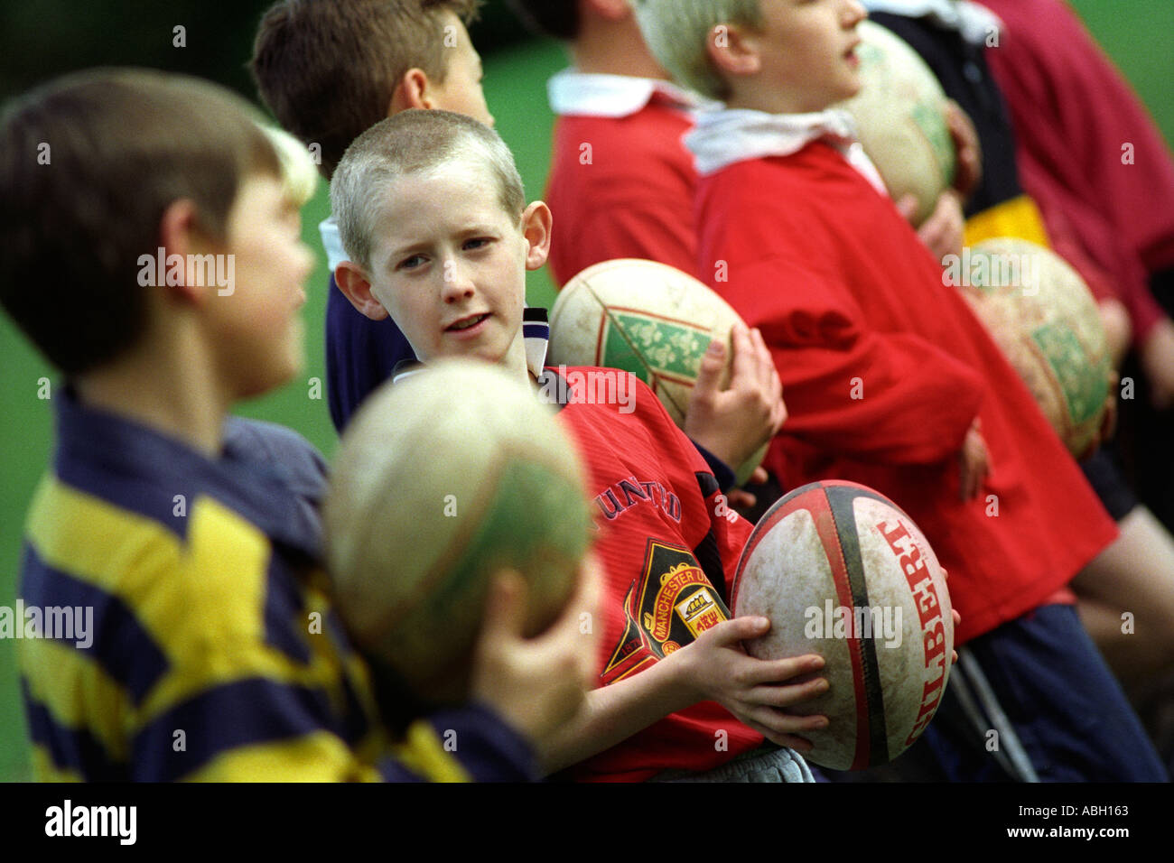 Children boys taking part in a rugby union coaching session to develop ball skills Stock Photo