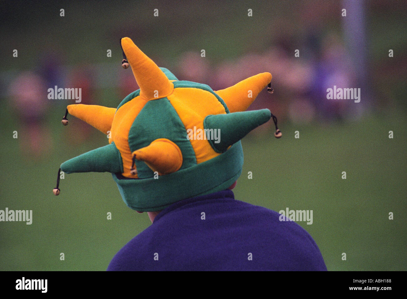Young boy in a jesters hat watching a rugby union match at Abercrave RFC Glamorgan South Wales UK Stock Photo