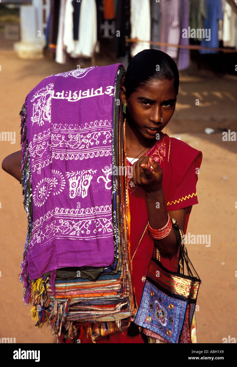 Young Indian female hawker carrying fabrics, Varkala Beach, Kerala, South India Stock Photo