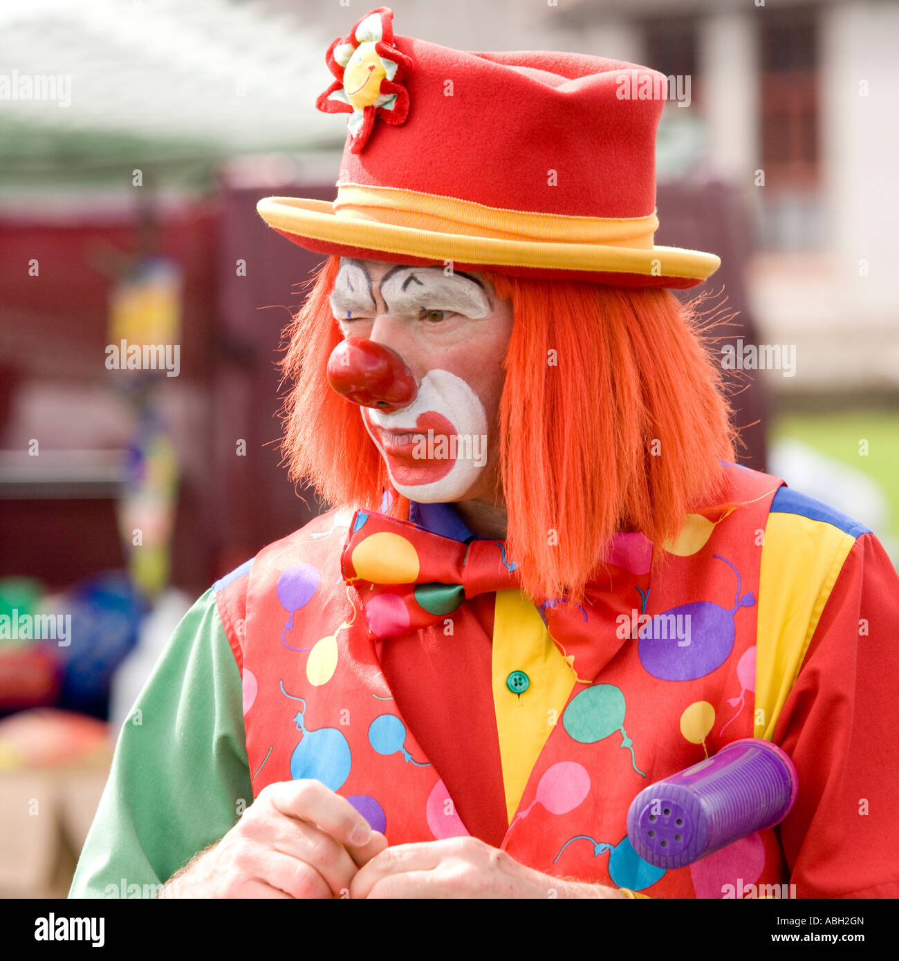 A clown making an animal out of balloons for children Annan Riding of the Marches Dumfriesshire Scotland UK Stock Photo