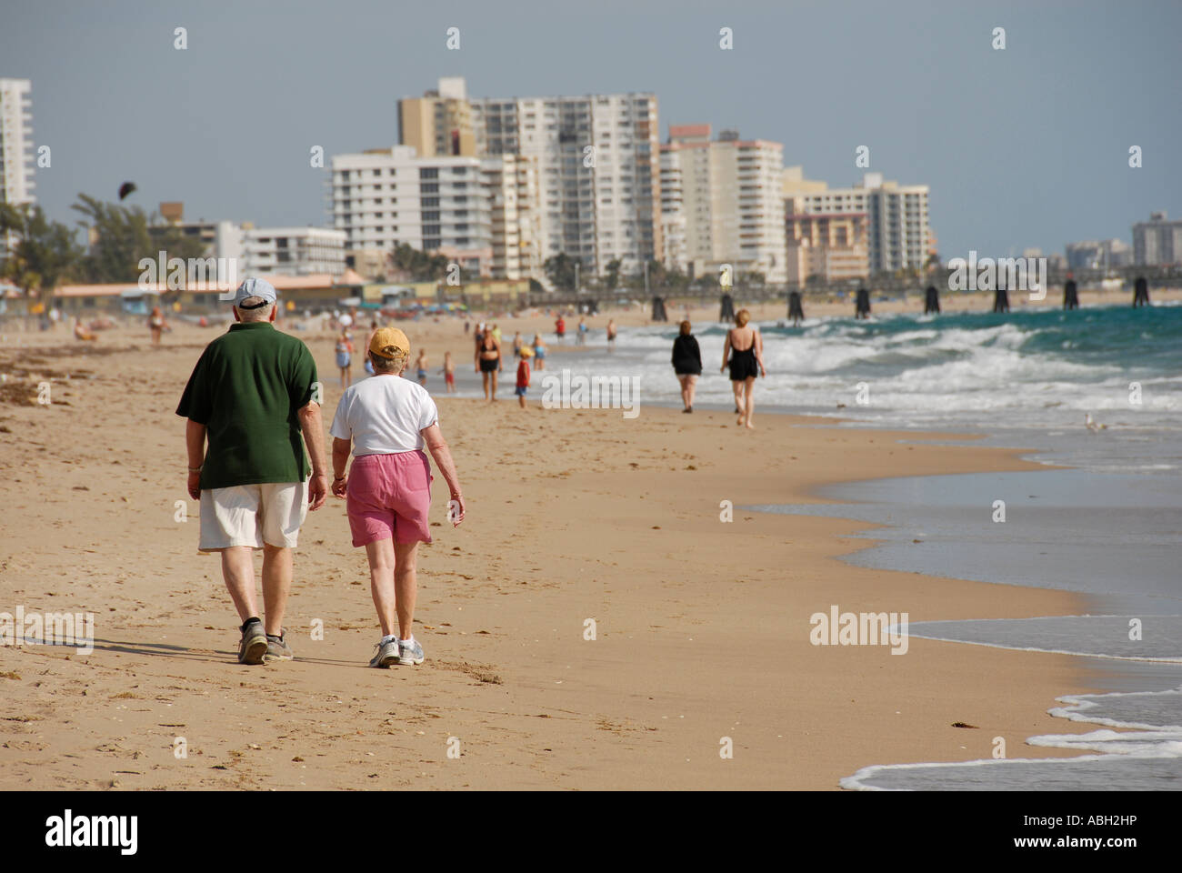 Older couple walking on beach Stock Photo