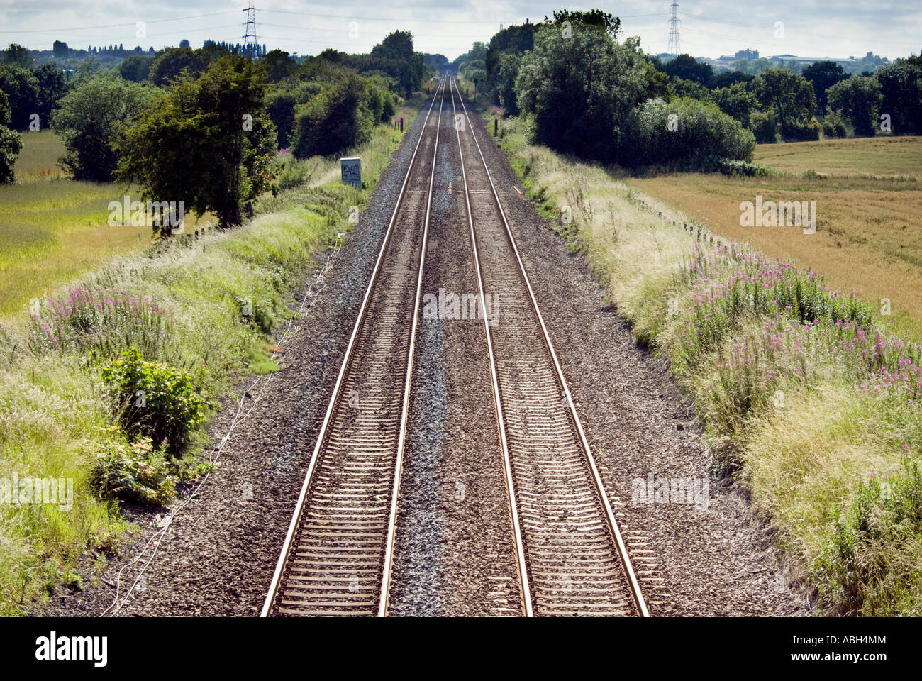 Converging railway lines disappear into the distance Stock Photo